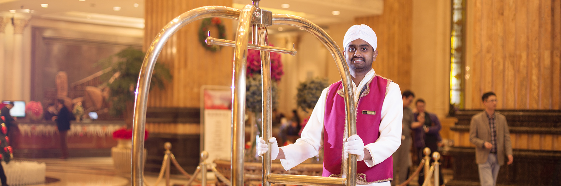 Staff at hotel helping carry guests luggage